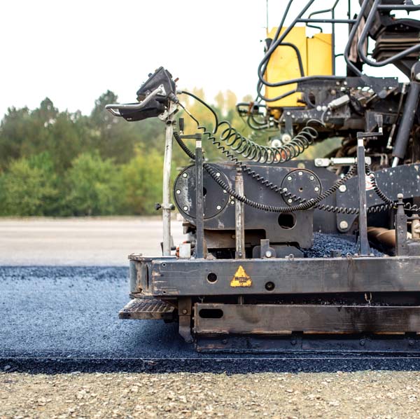 industrial pavement truck laying fresh asphalt on construction site, asphalting
