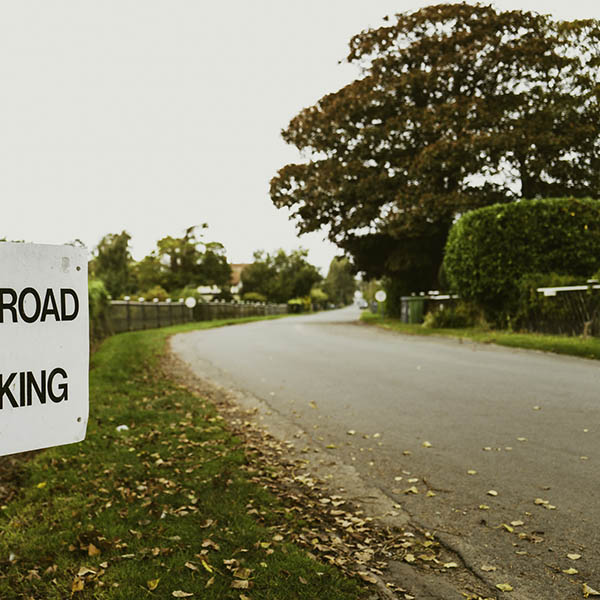 Shallow focus of a Private Road and No Parking sign seen at the entrance to private housing