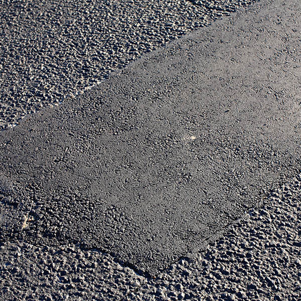 Asphalt Tarmac Patch on Concrete Ground Repair Pavement Road in Parking Lot