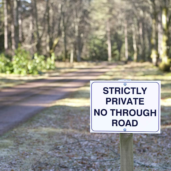 No through road strictly private road sign at entrance to estate grounds of woodlands forest land landmark in lake district uk