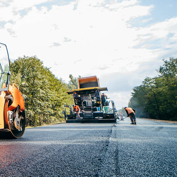 Vibratory asphalt rollers compactor compacting new asphalt pavement. Road service repairs the highway