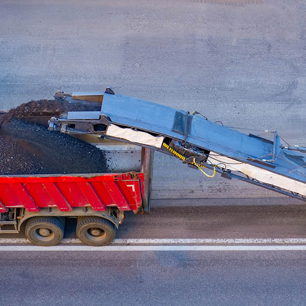 Asphalt removal repair using asphalt cutting and combine loading into truck body.